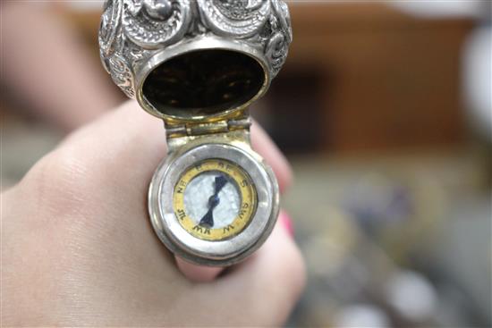 A Victorian walking stick with embossed silver pommel H.M., Birmingham 1906, opens to reveal a compass, overall length 89.5cm
